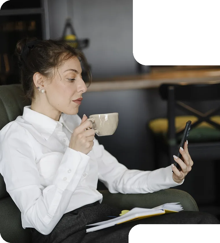 Reading mail on a phone with coffee